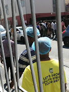 Onlookers gather round the car in which former Hard Livings leader Rashied Staggie was shot on December 13 2019.