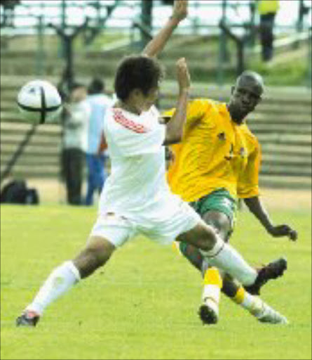 MY BALL: Innocent Mdledle of South Africa under - 23 national team fights for the ball with Liu Jianye of China in their Sasol Nations Cup match at Orlando Stadium in Soweto yesterday. Pic Antonio Muchave. 08/01/06. © Sowetan.