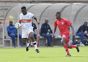 John Tshabalala of University of Pretoria and Sephelo Baloni of JDR Stars during their GladAfrica Championship match at Tuks Stadium on April 22, 2022 in Pretoria.