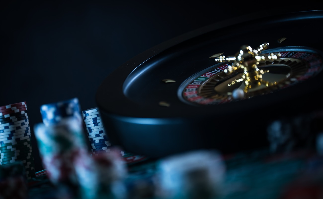 Roulette table in casino, with casino chips in a dark background