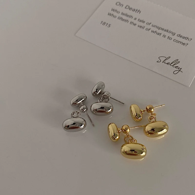 Brincos femininos estilo Ins, duplos em formato de feijão nas costas, banhados a ouro real sobre cobre, design moderno.
