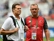 The Springboks head coach and director of rugby Rassie Erasmus (L) and the Emirates Lions head coach Swys de Bruin have a chat during the Super Rugby Super Hero Sunday match between the Lions and the Cell C Sharks at Cape Town Stadium on February 03, 2019.