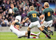 BOK STAMPEDE: Springboks' Ruan Pienaar passes while being tackled by England's Jamie Noon at Twickenham on Saturday. 22/11/2008. © Sportzpics/Second Left Images. Pic. Andrew Fosker.