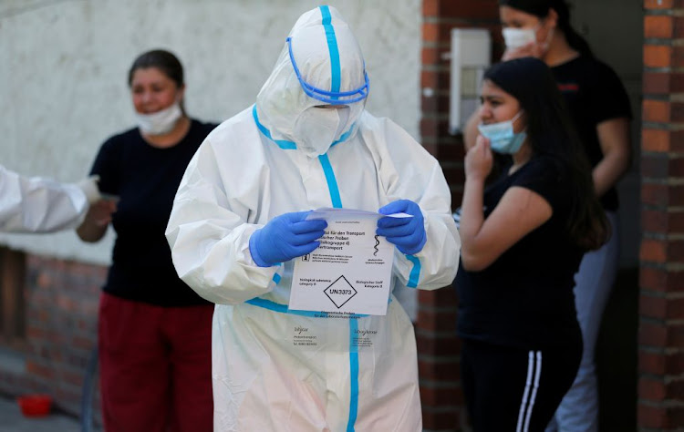 A member of a mobile testing unit of the German Army and German Red Cross is seen after testing residents for Covid-19, following an outbreak of the disease at Toennies meat factory which remains under lockdown, in Guetersloh, Germany, on June 22 2020.