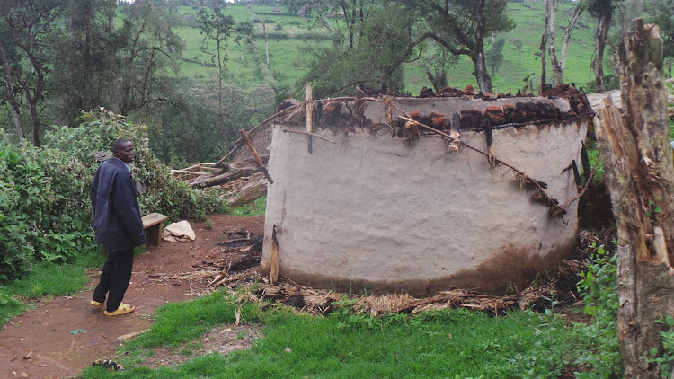 A man views his ruined house after KFS officers descended on settlers at Kipchoge in Narok South during Phase 1 evictions in 2018.