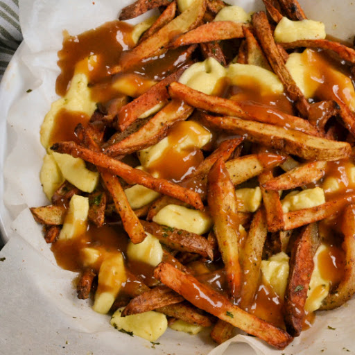 A popular Canadian Poutine dish with crispy homemade fries, warm stretchy fresh cheese curds, and flavorful rich beefy gravy.  If you are short on time simply substitute frozen French fries.