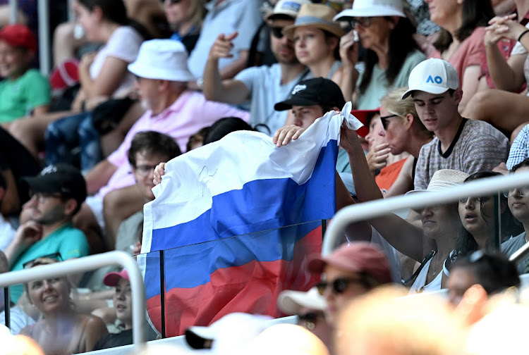 A Russian flag is displayed by spectators during the first round singles match between Andrey Rublev of Russia and Dominic Them of Austria at the 2023 Australian Open at Melbourne Park on January 17 2023.