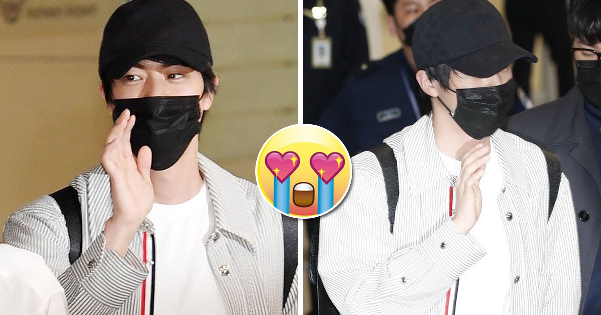 BTS' Jin waves for cameras at airport