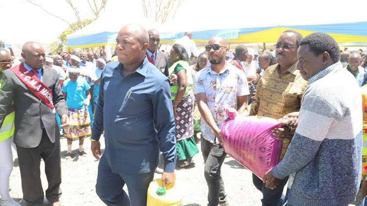 Machakos deputy governor Francis Mwangangi with Wiper leader giving gifts during an annual pilgrim mass at Komarock Shrines in Matungulu, Machakos County on Saturday, February 11, 2023.