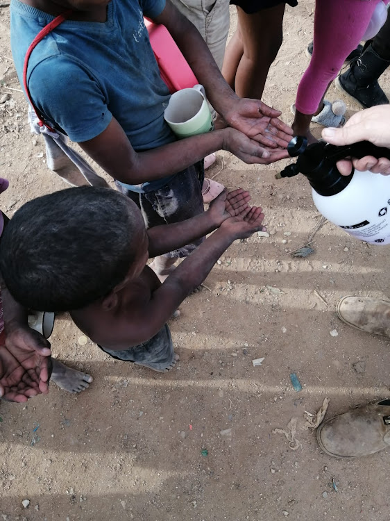 Tiny hands wait to be sanitized. Bredasdorp's informal settlement is situated next to the local landfill. For now other diseases contracted due to poor living conditions pose a greater risk to these children that COVID-19, which hasn't reached the town yet.