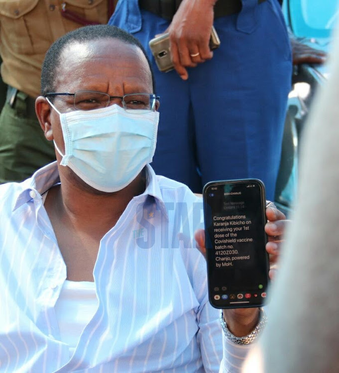 Interior PS Karanja Kibicho displays verification message after registering as a recipient of the Covid vaccine during the official roll out of the vaccination to the police service unit presided by the PS and Inspector General Mutyambai at police service HQ in Jogoo house Nairobi on Wednesday, 10 March