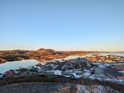 A view from the top of Maiden Tea Hill overlooks the seaside town of Burgeo, with the small Eclipse Island, named by Royal Navy explorer Captain James Cook in 1766, at top right in Newfoundland, Canada.  