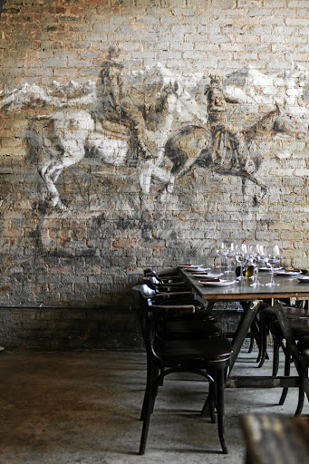 A mural of gauchos (horsemen) graces the wall of Che Argentine Grill.