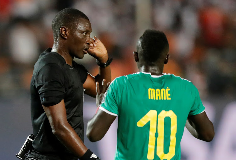 Referee Neant Alioum refers to VAR before reversing his decision to award Senegal a penalty