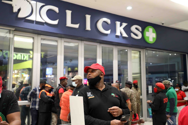 EFF supporters protest outside the Sandton City Clicks store, in Johannesburg, causing it to close. Clicks caused an outcry across the country on Friday after posting an advert on its website depicting black women's hair as dry and damaged, and white women's hair as fine and flat.