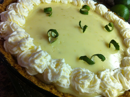 Key lime pie with whipped cream and lime on top