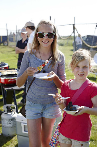 Girls chowing down at the Lighthouse Festival in North Rustico, Prince Edward Island, Canada.