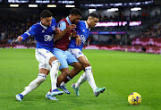 Everton's Ben Godfrey and Lewis Dobbin in action with Burnley's Lyle Foster (centre).