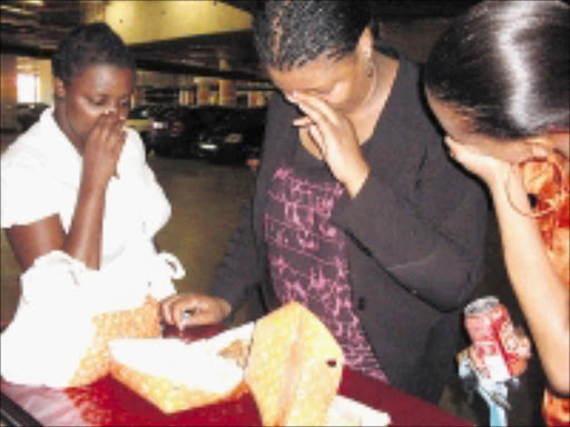 BAD SMELL: Rudzi Mashige, Puseletso Lepele and Lerato Mafora, who claim they bought chicken in Randburg only to find that it was rotten. Cicra 2008. Pic. Sibongile Mashaba. © Sowetan.