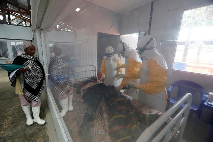 Moise Vaghemi, 33, (C) an Ebola survivor who works as a nurse, cares for a patient who is suspected to be suffering from Ebola, inside the Biosecure Emergency Care Unit (CUBE) at the Ebola treatment centre in Katwa, near Butembo, in the Democratic Republic of Congo, October 3, 2019. REUTERS/Zohra Bensemra