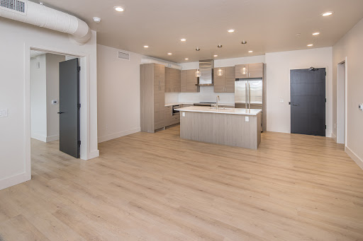 Modern kitchen with central island and refrigerator in this luxury apartment / penthouse for sale in Big Sky ($1,695,000)