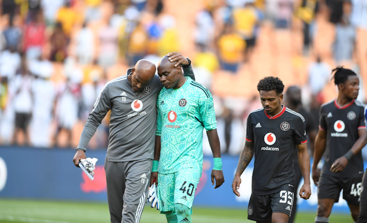 Orlando Pirates' goalkeeper coach Tyrone Damons consoles keeper Siyabonga Mpontshane after the DStv Premiership Soweto derby against Kaizer Chiefs at FNB Stadium on October 29.