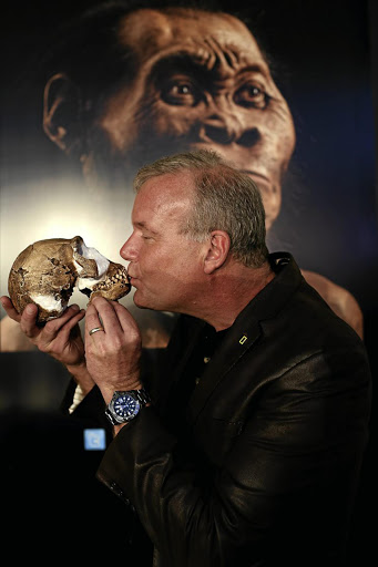 Professor Lee Berger, of Wits University, kisses a 'Homo naledi' skull. His interpretations of recent findings have been questioned by a colleague, Professor Francis Thackeray.