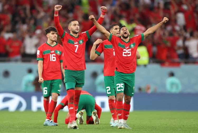 Hakim Ziyech and Yahya Attiat-Allah of Morocco celebrate during the penalty shootout as they beat Spain in their World Cup last-16 match at Education City Stadium in Al Rayyan, Qatar on December 6 2022.