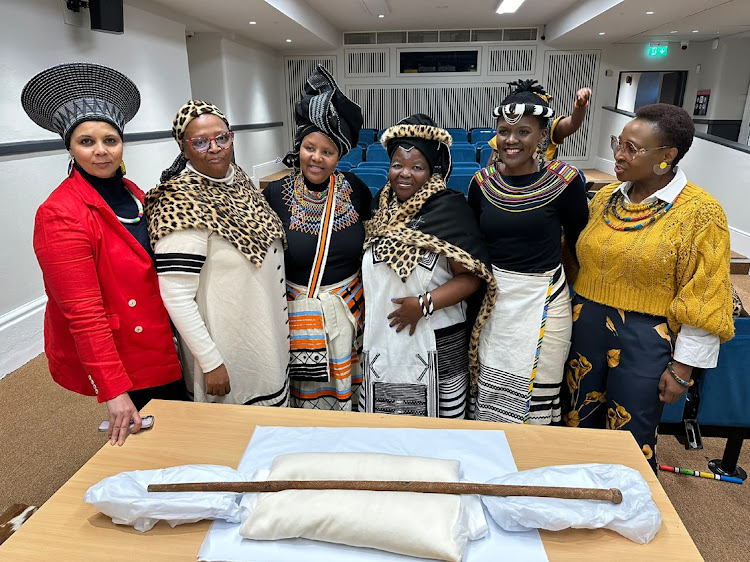 A South African delegation that took part in the play about the life and times of Nkosi Jongumsobomvu Maqoma at the National Museum of Ireland. In front of them is the stick that belonged to Maqoma.