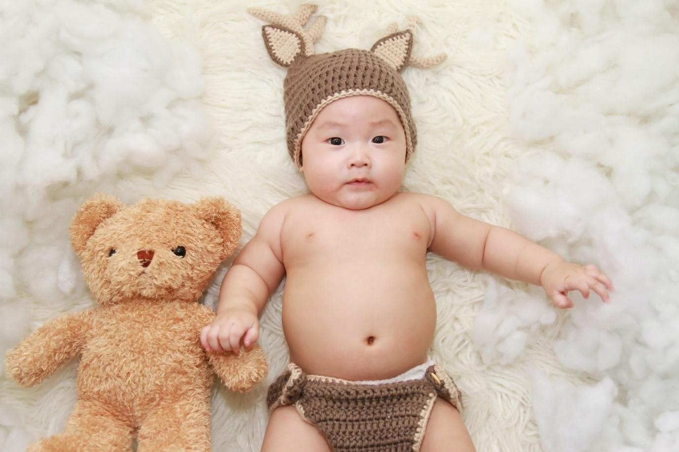 A newborn lying on the bed