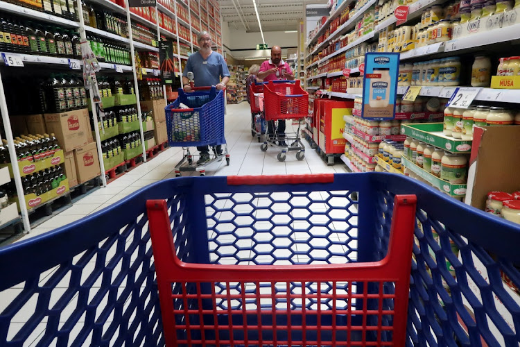 People push shopping cart in a Carrefour supermarket in Cabrera de Mar, near Barcelona, Spain May 19, 2017.