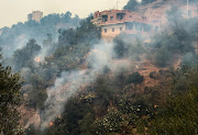 Smoke rises from a forest fire in the mountainous Tizi Ouzou province, east of the Algerian capital, Algiers, August 10, 2021.  