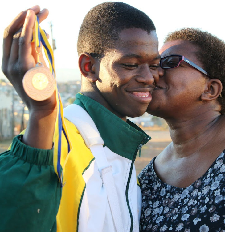 Judo star Lithemba Magajana is congratulated by his mother Nomphumelelo after returning home from Burundi