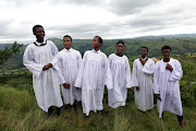 Young men pose for a photograph after a church service at Nhlangakazi mountain.