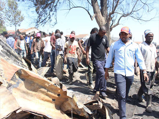 Lang'ata constituency member of Parliament Nixon Korir visits the area where houses were burnt./ EZEKIEL AMINGÁ