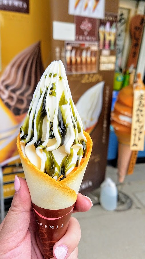 Hiroshima Day trip to Miyajima. You can get deer poop ice cream, or opt for premium Cremia ice cream as shown here that is higher quality as it is higher milk fat (12.5%) content that includes some 25% fresh cream, and the milk is sourced from specially selected Hokkaido cows and comes in a cone of langue de chat that is much better then any regular cone.