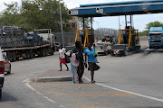 Zimbabweans go about their business near the Beitbridge border post in Musina yesterday.