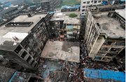 Rescue workers search for survivors from the debris after a three-storey residential building collapsed in Bhiwandi on the outskirts of Mumbai, India on September 21 2020. 
