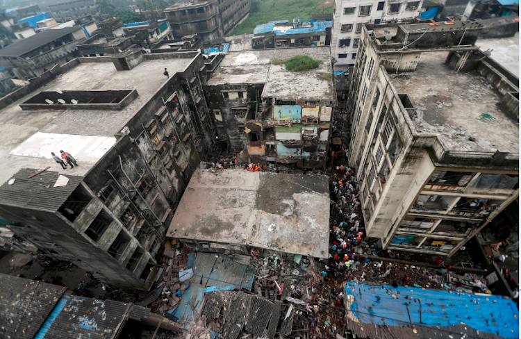 Rescue workers search for survivors from the debris after a three-storey residential building collapsed in Bhiwandi on the outskirts of Mumbai, India on September 21 2020.