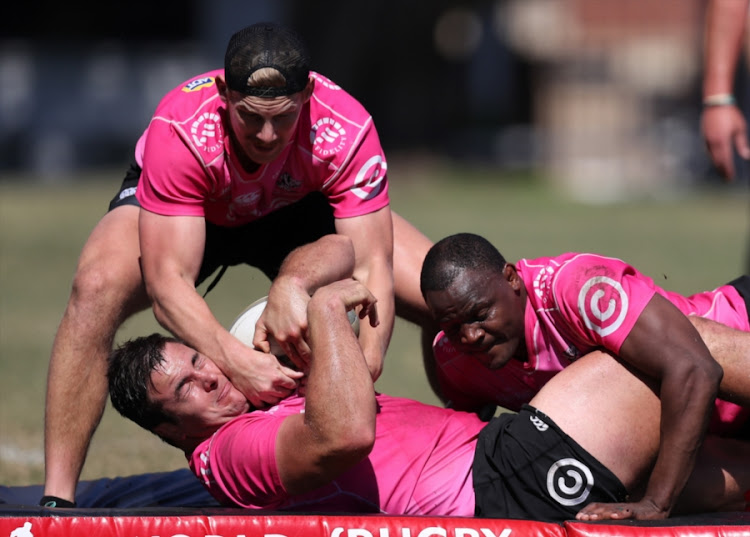 Robert du Preez Jnr. tries to steal the from the grasp of Juan Schoeman (C) who is also being tackled by Mahlatse "Chilliboy" Ralepelle during the Cell C Sharks training session at Jonsson Kings Park on August 28, 2018 in Durban, South Africa.