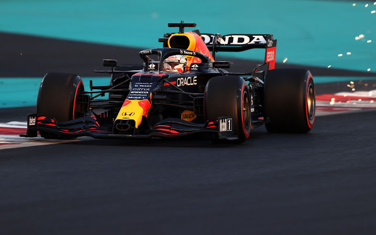 Sparks fly behind Max Verstappen during qualifying ahead of the F1 Grand Prix of Abu Dhabi at Yas Marina Circuit on December 11, 2021 in Abu Dhabi, United Arab Emirates.