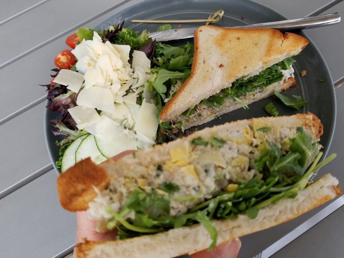 Chicken and artichoke salad with arugula on gluten free bread.