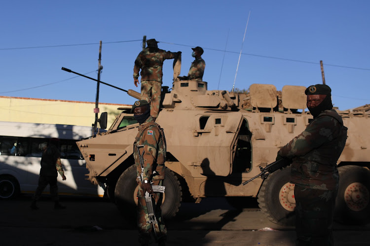 Members of the South African Defence Force patrol in Alexandra, Johannesburg.