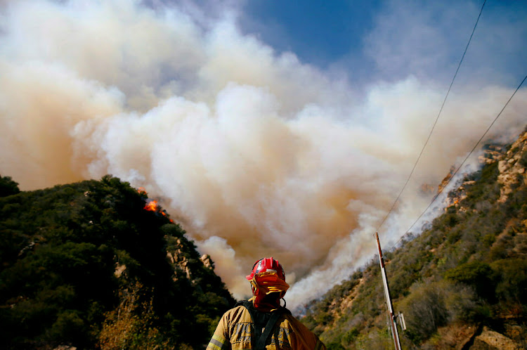 Firefighters battle the Woolsey Fire as it continues to burn in Malibu, California, US.