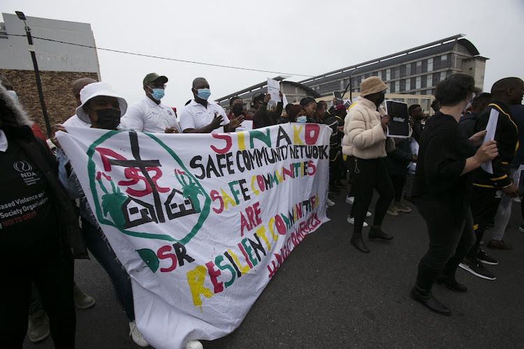 A crowd outside the East London's Magistrate's Court protest against gender-based violence during the appearance of Alutha Pasile, who stands accused of the murder and dismemberment University of Fort Hare law student Nosicelo Mtebeni.