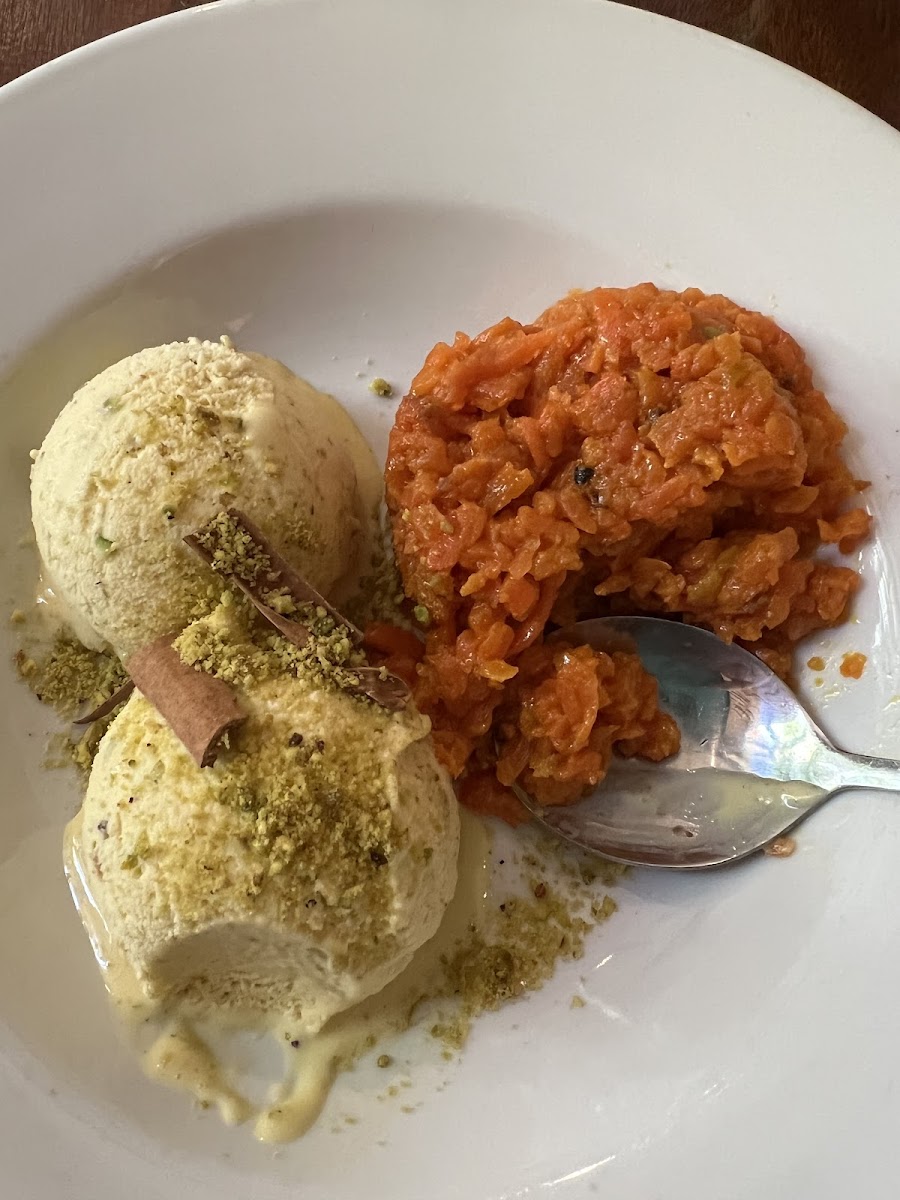 Gajar Halwa dessert. A warm carrot pudding (tastes like shredded apple with cinnamon, cardamom (?), and pistachios) with vanilla ice cream dusted with pistachios