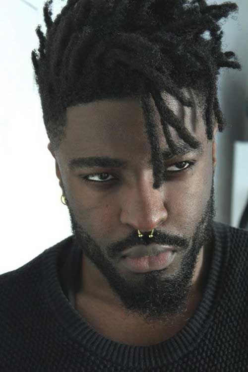 a black man with a nose ring wearing a dread male hairstyle