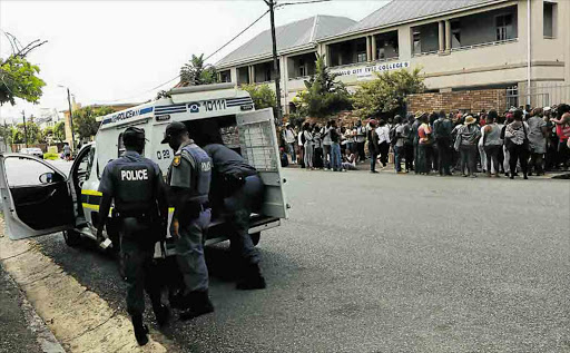 Buffalo City College students seen outside the gates of the St Marks Campus in Southernwood Picture: MICHAEL PINYANA