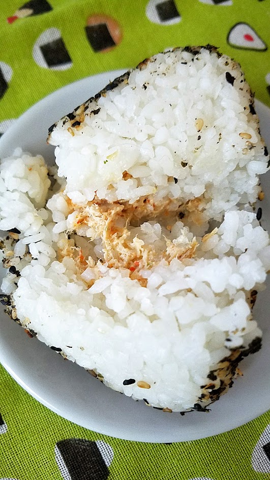 Musubi Portland's onigiri, naked without the seaweed sheet and cut in half so you can see the spicy tuna mayo filling here