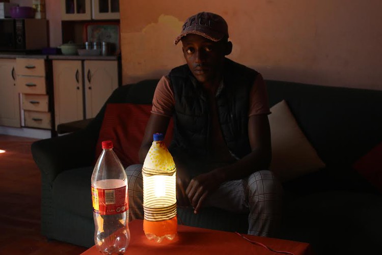 Siphamandla Ntshewula hopes to sell his plastic bottle lamps to pupils to help them study at night.